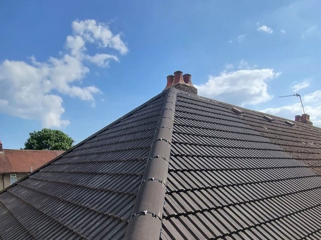 New ridge tiles bedded and pointed