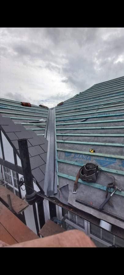 Stripped back to new membrane and battens, lead hip going in